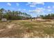 Newly constructed home boasts a large, partially cleared backyard with wooded areas at 11910 Sw 43Rd Street Road, Ocala, FL 34481