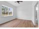 Bright bedroom with a ceiling fan and a large window overlooking a wooded landscape at 11910 Sw 43Rd Street Road, Ocala, FL 34481