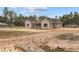 A view of the home's back exterior showing the lot, driveway and gray toned exterior at 11910 Sw 43Rd Street Road, Ocala, FL 34481