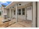 A view of the home's front porch with white columns and a modern front door at 11910 Sw 43Rd Street Road, Ocala, FL 34481