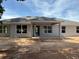 Rear of the home featuring a covered patio and several large windows offering lots of natural light at 13 Nw 45Th Loop, Ocala, FL 34475