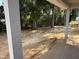 View from the covered patio of the home's backyard with a wood fence surround at 13 Nw 45Th Loop, Ocala, FL 34475