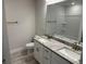Bathroom featuring double sinks, granite countertop, white cabinets, and a large mirror at 13 Nw 45Th Loop, Ocala, FL 34475