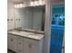 Bathroom featuring double sinks with granite countertops and modern lighting at 13 Nw 45Th Loop, Ocala, FL 34475