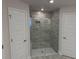 Modern bathroom featuring a glass enclosed shower with gray tile surround and tile floor at 13 Nw 45Th Loop, Ocala, FL 34475