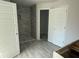 New bathroom with tile shower, gray tile walls and gray tile flooring, and double doors at 13 Nw 45Th Loop, Ocala, FL 34475