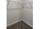 Walk-in closet with wire shelving and neutral carpet, offering ample storage space at 13 Nw 45Th Loop, Ocala, FL 34475