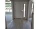 Bright entryway with white door and light-colored tile flooring at 13 Nw 45Th Loop, Ocala, FL 34475