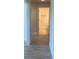 Hallway with wood-look tile flooring leading to a bathroom with an open door at 13 Nw 45Th Loop, Ocala, FL 34475