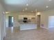 Open-concept kitchen with white cabinets, stainless appliances, and a kitchen island at 13 Nw 45Th Loop, Ocala, FL 34475
