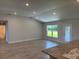 Spacious open-concept living room with tile flooring and a granite-topped breakfast bar at 13 Nw 45Th Loop, Ocala, FL 34475