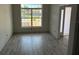 Open living room with tile floors and a large window, perfect for entertaining guests at 13 Nw 45Th Loop, Ocala, FL 34475