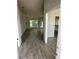 Open concept living space featuring modern tile floors, large windows and an unfinished kitchen area at 13 Nw 45Th Loop, Ocala, FL 34475