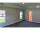 Large bedroom featuring tray ceilings and a connecting door to the bathroom at 13 Nw 45Th Loop, Ocala, FL 34475