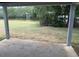 View of the backyard and greenery from the covered outdoor patio at 13 Nw 45Th Loop, Ocala, FL 34475