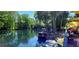 Scenic view of the river featuring a boat dock and outdoor dining area at 13 Nw 45Th Loop, Ocala, FL 34475