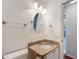 Bathroom with granite vanity, oval mirror, and toilet at 1509 Hollyberry Pl, The Villages, FL 32162