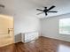 Bedroom with wood floors and dresser at 1509 Hollyberry Pl, The Villages, FL 32162