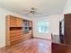 Bright bedroom with wood floors, built-in shelving, and window at 1509 Hollyberry Pl, The Villages, FL 32162