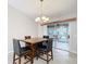 Bright dining area with table and chairs, leading to a screened porch at 1509 Hollyberry Pl, The Villages, FL 32162