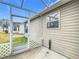 Exterior view of house with screened patio and yard at 1509 Hollyberry Pl, The Villages, FL 32162