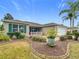 Landscaped front yard with a single story home and attached garage at 1509 Hollyberry Pl, The Villages, FL 32162