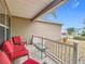 Front porch with red chairs, small table, and white railing at 1509 Hollyberry Pl, The Villages, FL 32162