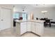 Kitchen island with white cabinets and granite countertop at 1509 Hollyberry Pl, The Villages, FL 32162