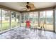 Sunroom with tiled floor, ceiling fan, and patio furniture at 1509 Hollyberry Pl, The Villages, FL 32162