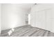 Bedroom with grey flooring, white walls, and a built-in closet at 15413 Sw 65Th Terrace Rd, Ocala, FL 34473