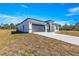 House exterior view with gray garage door at 15413 Sw 65Th Terrace Rd, Ocala, FL 34473