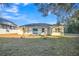 House backyard view with open space and trees at 16360 Se 88Th Ct, Summerfield, FL 34491