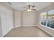 Bedroom with vinyl flooring, double door closet and window at 16360 Se 88Th Ct, Summerfield, FL 34491