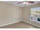 Simple bedroom with a large window and wood-look floors at 16360 Se 88Th Ct, Summerfield, FL 34491