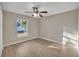 Spacious bedroom with wood-look floors and ceiling fan at 16360 Se 88Th Ct, Summerfield, FL 34491