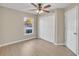 Bright bedroom with wood-look floors and double doors at 16360 Se 88Th Ct, Summerfield, FL 34491