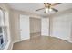 Bedroom with vinyl flooring, double door closet and access to office at 16360 Se 88Th Ct, Summerfield, FL 34491