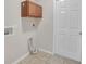 Laundry room with cabinets, tile flooring, and a door to outside at 16360 Se 88Th Ct, Summerfield, FL 34491