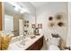 Clean bathroom with updated vanity, large mirror, and tiled shower/tub combo at 1795 Se Clatter Bridge Rd # 1795, Ocala, FL 34471