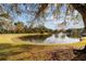 Peaceful pond view with mature trees and lush greenery at 1795 Se Clatter Bridge Rd # 1795, Ocala, FL 34471