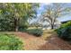 Landscaped walkway leading to a scenic pond with fountain at 1795 Se Clatter Bridge Rd # 1795, Ocala, FL 34471