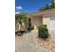 Single-story house with a palm tree, front door, and two-car garage on a sunny day at 1801 Marquez Loop, Lady Lake, FL 32159