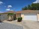 Charming single-story home with a well-manicured lawn and a two-car garage at 1801 Marquez Loop, Lady Lake, FL 32159