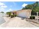 Exterior view of a single-story house with a driveway, lamp post, and landscaped yard at 1801 Marquez Loop, Lady Lake, FL 32159