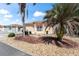 Exterior view of a single-story house with a landscaped yard featuring rock and mulch ground cover at 1801 Marquez Loop, Lady Lake, FL 32159