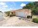 Exterior view of a single-story house with a driveway, lamp post, and landscaped yard at 1801 Marquez Loop, Lady Lake, FL 32159