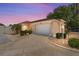 Exterior view of a single-story house with a driveway, lamp post, and landscaped yard at dusk at 1801 Marquez Loop, Lady Lake, FL 32159