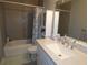 Clean bathroom with white vanity and tub at 23092 Sw Nautilus Blvd, Dunnellon, FL 34431