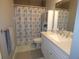 Bathroom with white vanity, shower/tub combo at 23092 Sw Nautilus Blvd, Dunnellon, FL 34431