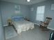 Bright bedroom with a full bed and rocking chair at 23092 Sw Nautilus Blvd, Dunnellon, FL 34431